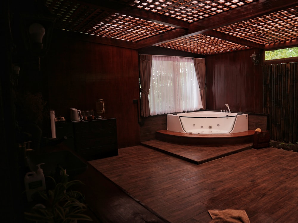 Warm, softly lit treatment room with a private soaking tub and wood paneled interior